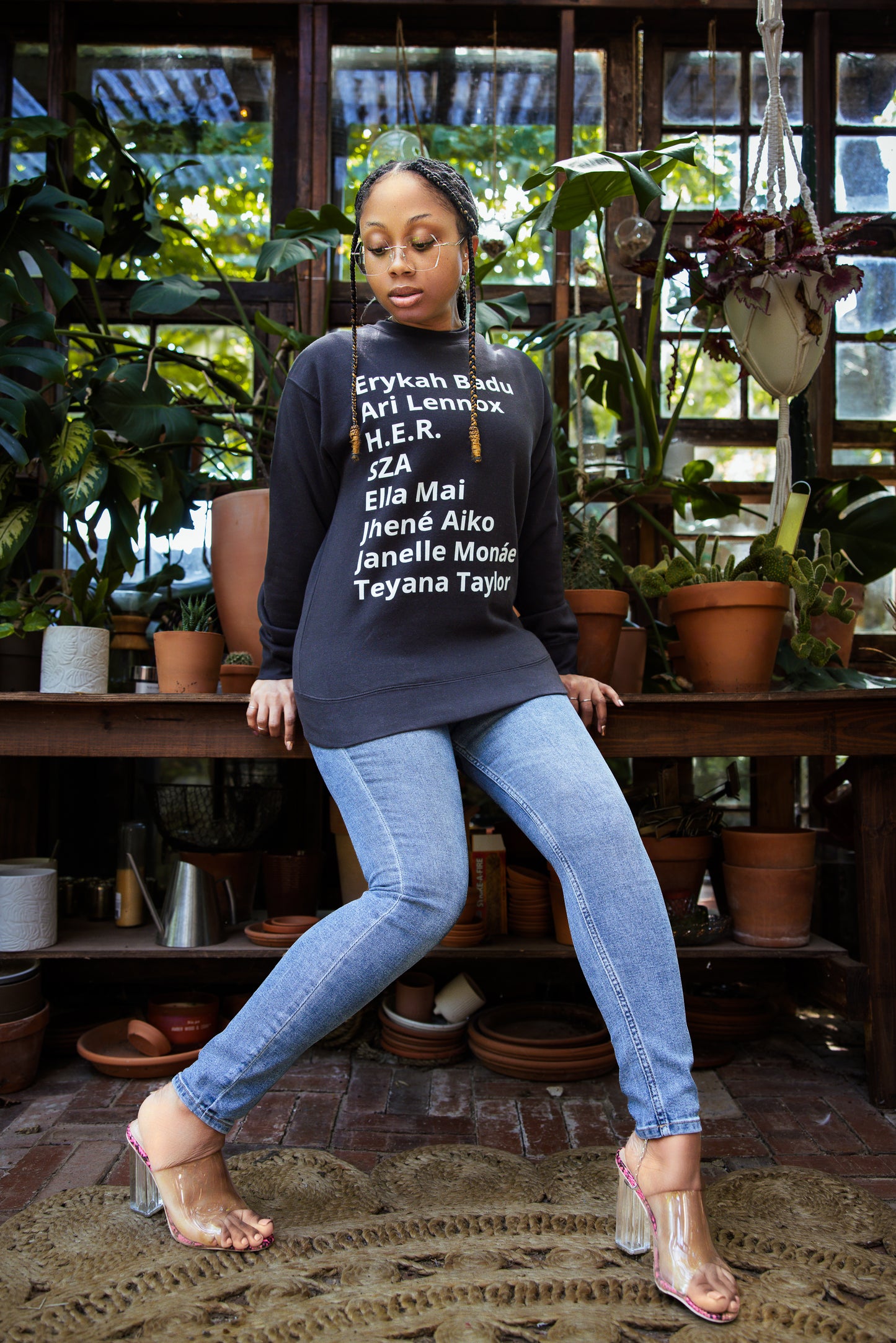 - Sweater with minimalist typography listing female R&B singers: Erykah Badu, Ari Lennox, H.E.R., SZA, Ella Mai, Jhene Aiko, Janelle Monae, and Teyana Taylor.