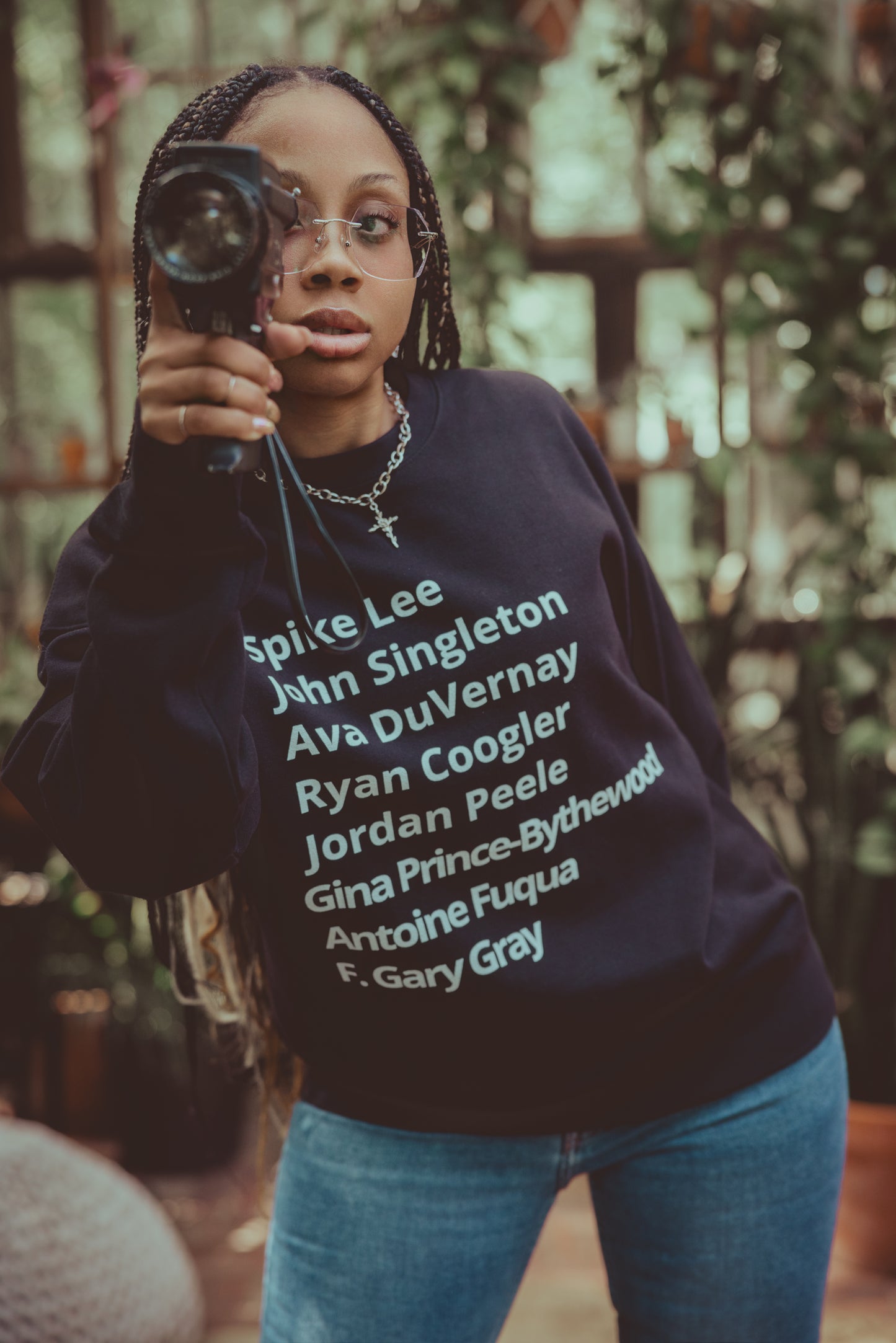 crew neck sweater with minimalist typography listing black filmmakers and cinema directors: Spike Lee, John Singleton, Ava DuVernay, Ryan Coogler, Jordan Peele, Gina Prince-Bythewood, Antoine Fuqua, F. Gary Gray