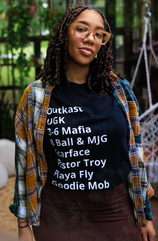 women with - T-Shirt with minimalist typography listing southern hip-hop rappers: Outkast, UGK, 3-6 Mafia, 8 Ball & MJG, Scarface, Pastor Troy, Playa Fly, and Goodie Mob